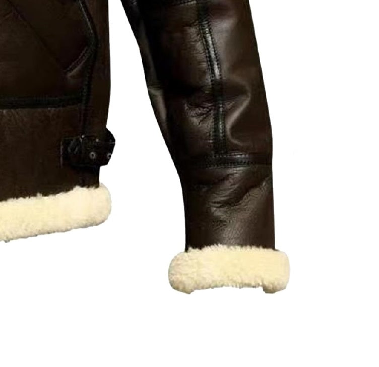 Close-up of a brown leather jacket with white fur lining on cuffs and hem against