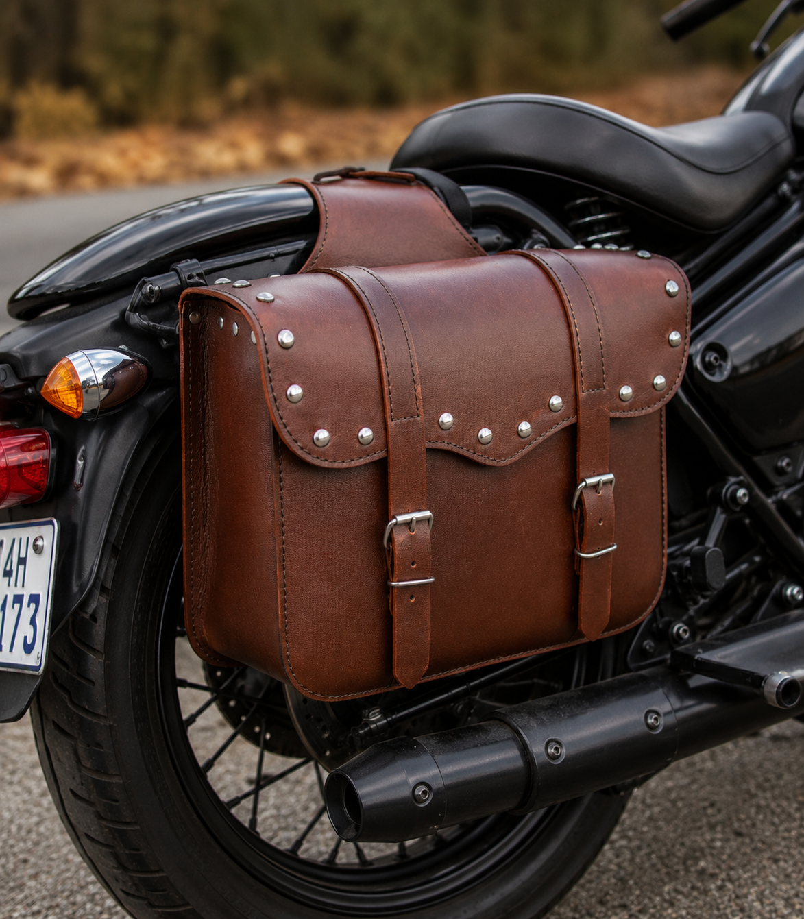 Brown leather saddlebag with studs on a motorcycle