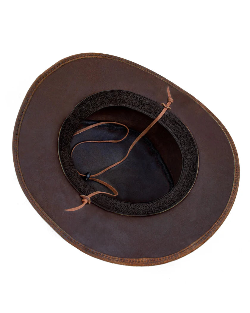 Interior view of a brown leather cowboy hat showing the padded sweatband, inner crown lining, and adjustable chin strap attachment.