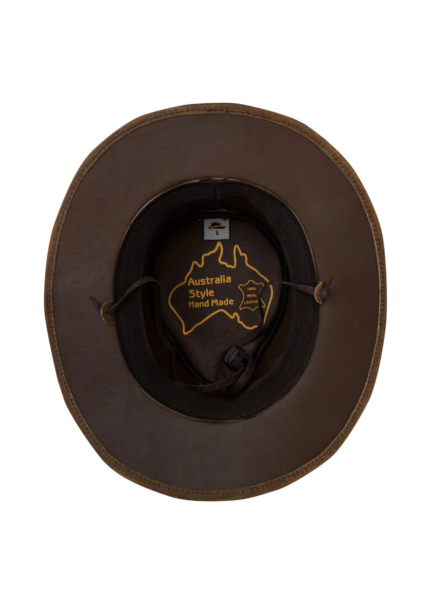A brown leather wide-brim hat viewed from above, showing the interior with a gold outline logo of Australia and the text 'Australia Style Hand Made'.