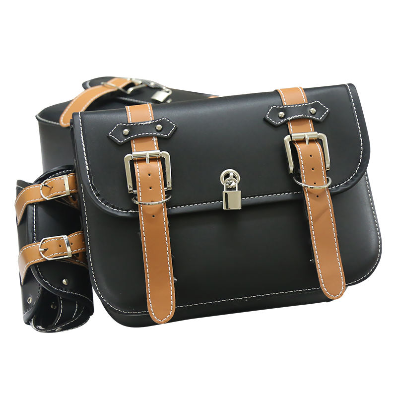 Black leather bag with brown straps and silver buckles on a white background