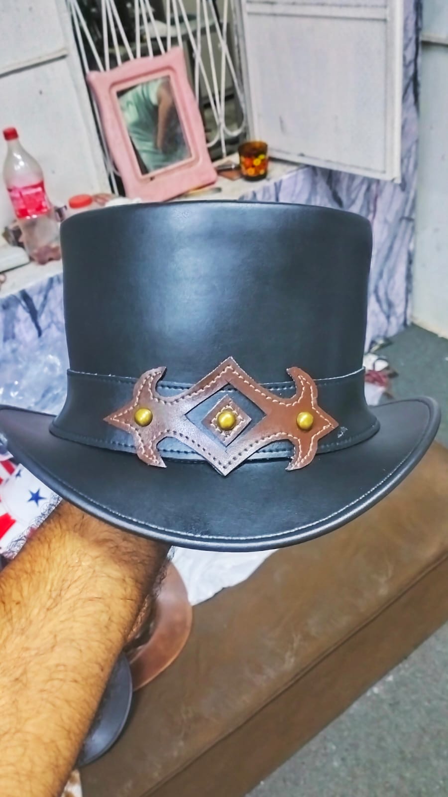 Craftsman holding handmade black leather steampunk top hat – Like Leather