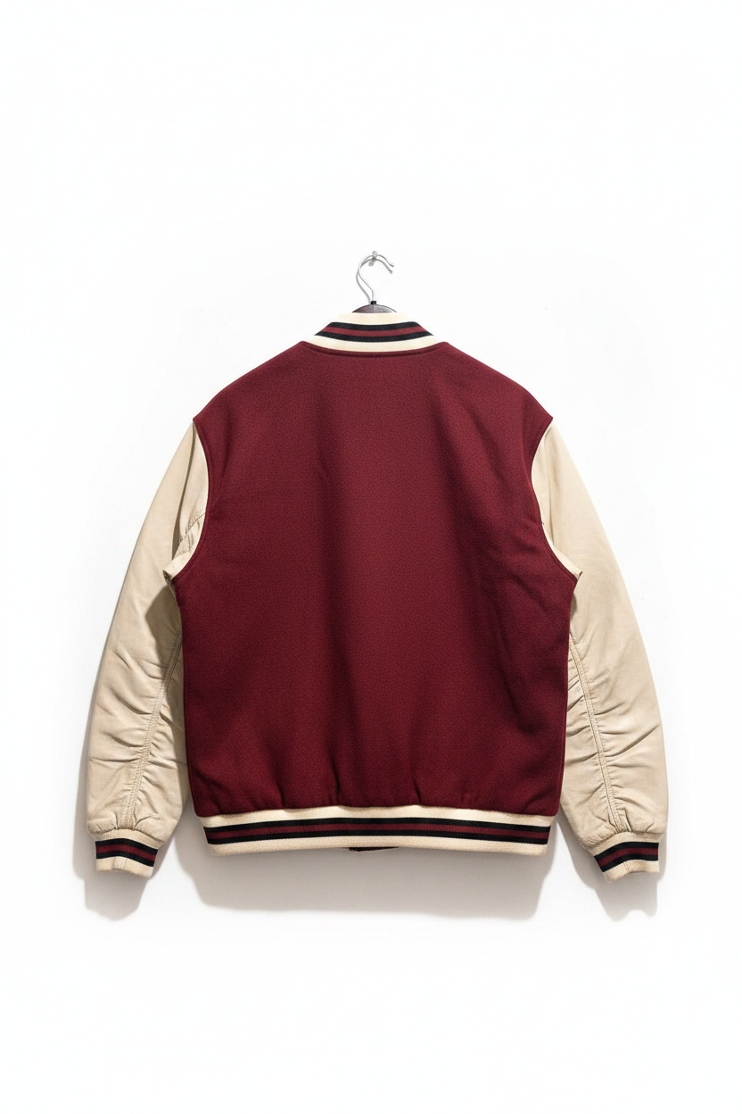 A maroon and beige varsity-style jacket shown from the back, hanging on a metal hanger against a plain white background.