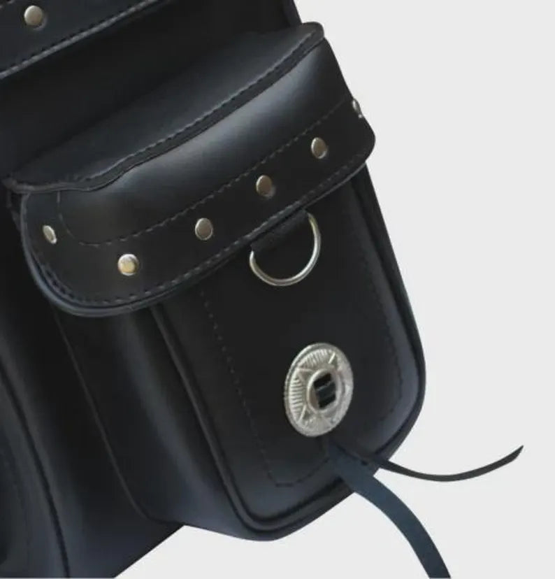 Close-up of a black leather bag with silver studs and a metal clasp
